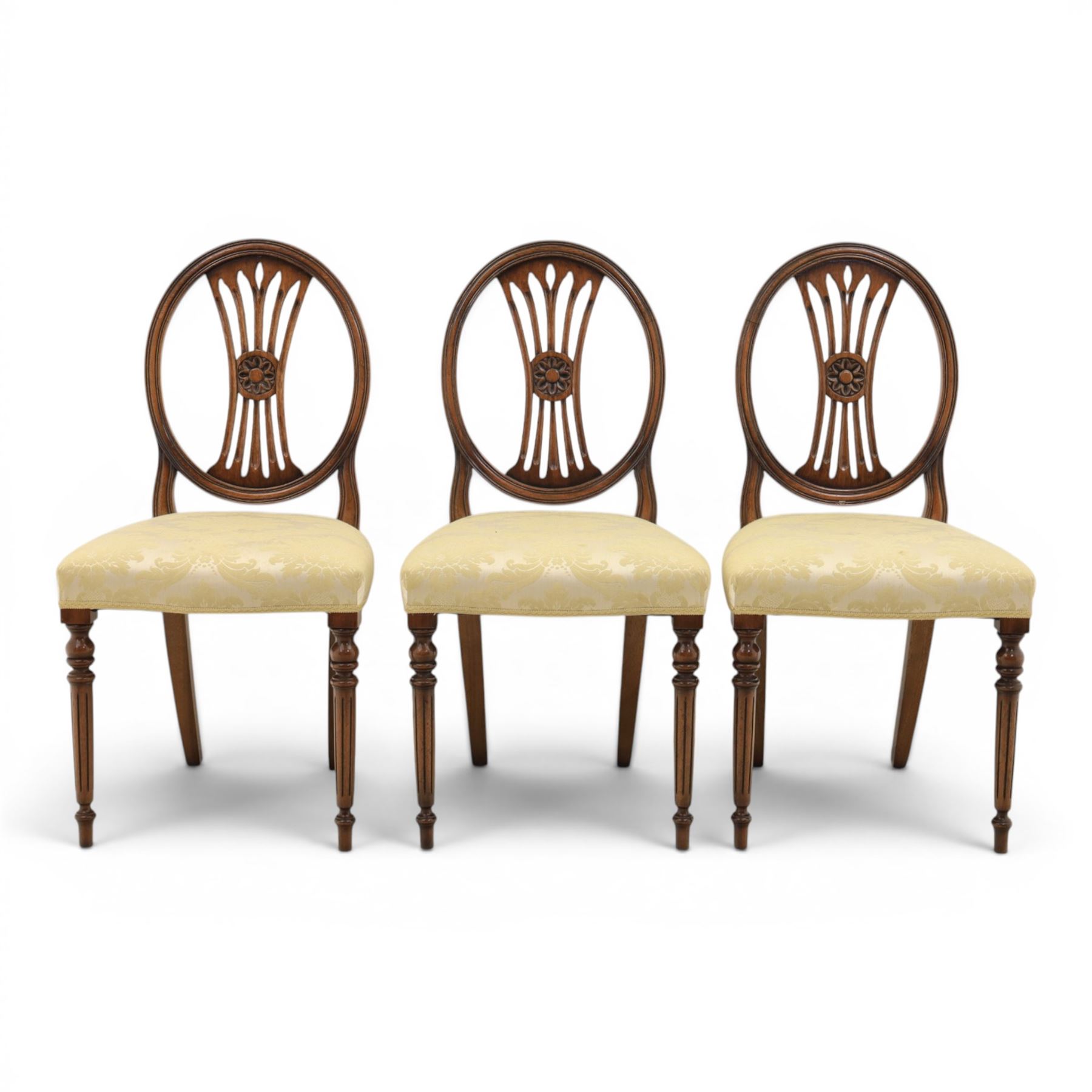 Bevan Funnell Reprodux - Regency design set of ten mahogany dining chairs, oval backs with central splat with rose motif, serpentine seat upholstered in damask fabric, raised on turned supports
