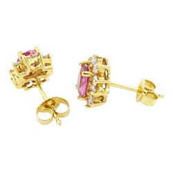 Pair of 18ct gold pink sapphire and diamond cluster earrings, each stud set with an oval cut sapphire, surrounded by ten round brilliant cut diamonds, Birmingham 2006, total sapphire weight approx 1.00 carat, total diamond weight approx 0.60 carat