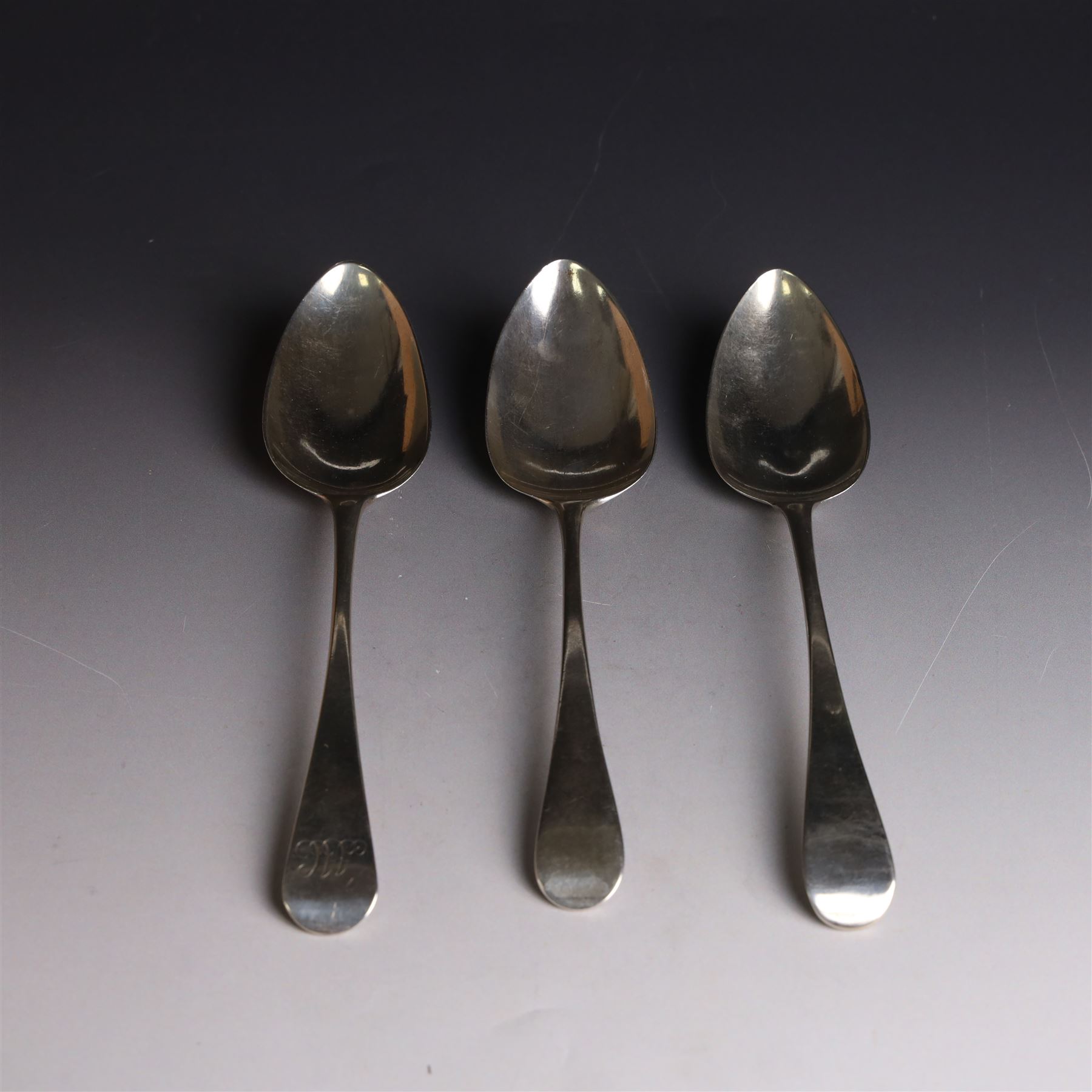Three George III silver Old English pattern table spoons, one with engraved monogram to terminal, hallmarked Solomon Hougham, London 1802, a further example hallmarked London 1805, makers mark indistinct and one other hallmarked George Wintle, London 1807