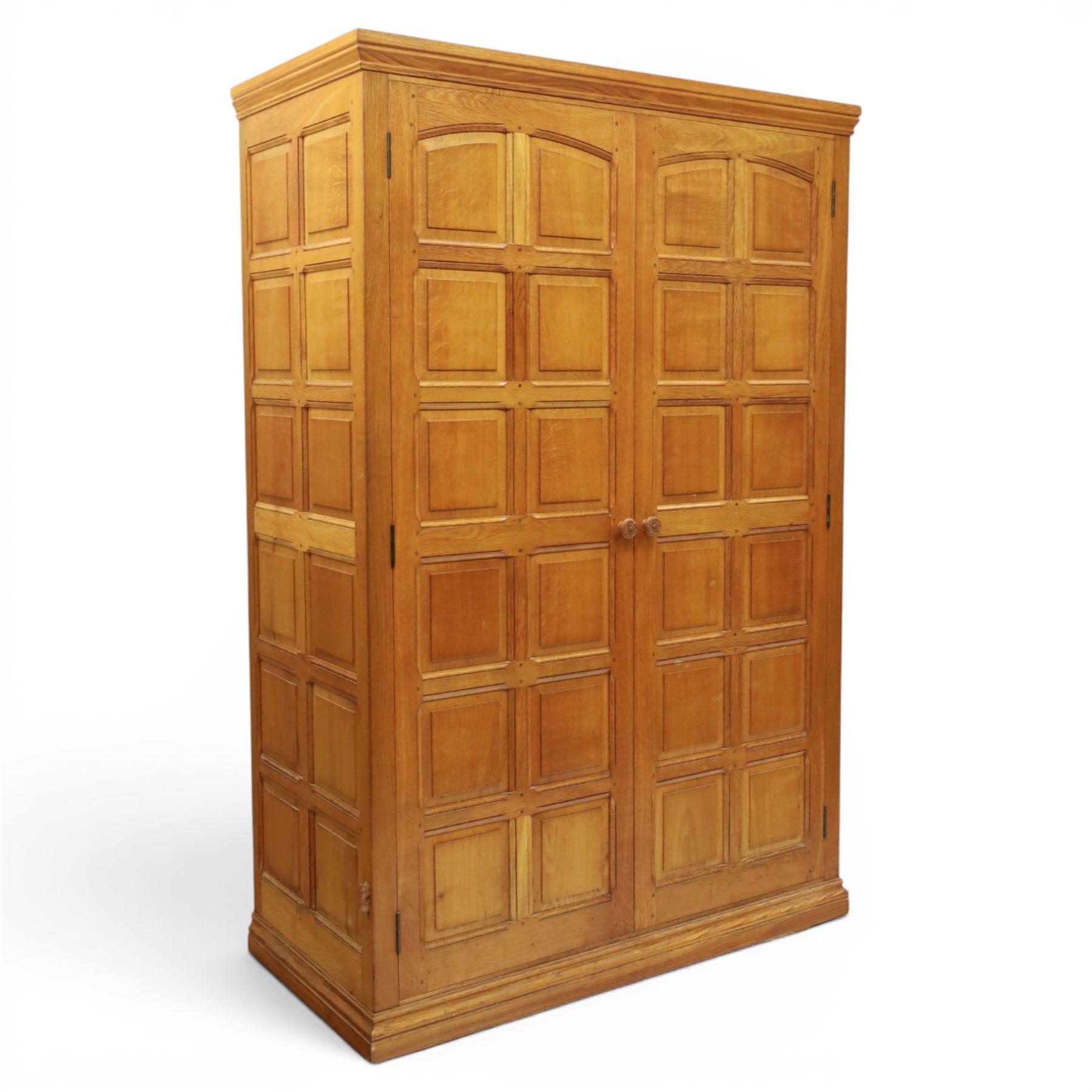 Beaverman - oak double wardrobe, enclosed by twin multi-panelled doors, Yorkshire Rose carved handles, the interior fitted with shelf and hanging rail, with signature carved beaver, by Colin Almack of Sutton, near Thirsk