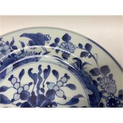 Japanese Meiji period Arita blue and white plate, of circular form, painted with riverside landscape and bird upon flowering branch, with character mark beneath, D24.5cm, together with two 18th century Chinese blue and white plates, each painted with floral design, each approximately D22.5cm