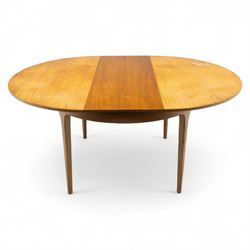 Sutcliffe of Todmorden - mid 20th century ‘S-Form’ teak dining table and chairs, the circular storable extending table with plain veneered top on tapered supports, together with matching dining chairs upholstered in black vinyl, with curved slat backs and shaped front supports, reflecting the sleek organic styling characteristic of 1960s British modern furniture design (Chairs H 93cm, W 46cm, D 46cm) (Extended 168cm)