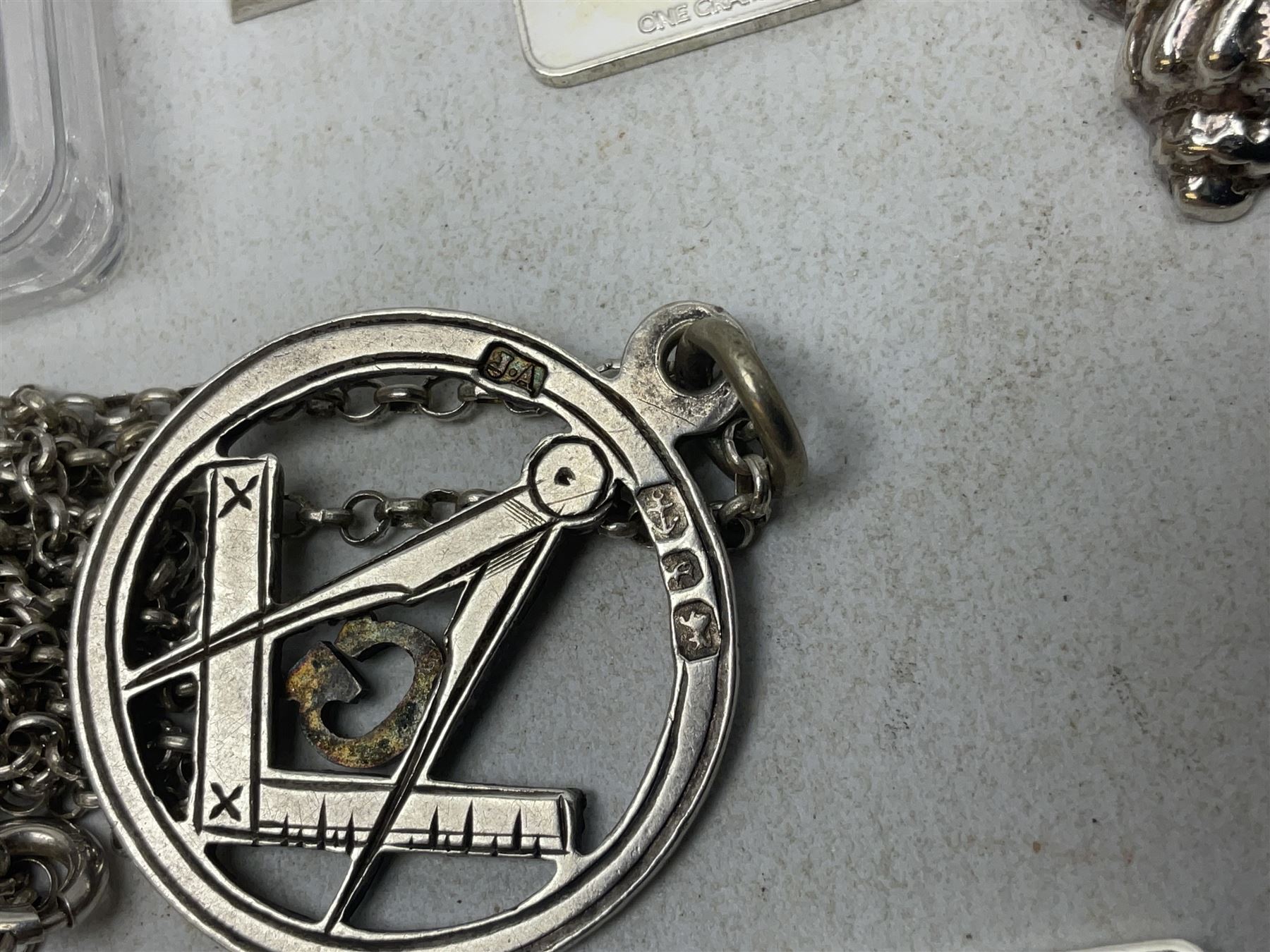 Silver mother of pearl handled fruit knife, silver jewellery including masonic pendant necklace, shell pendant, coin ring, Claddagh ring and charms etc, and a collection of ingots