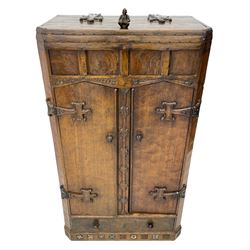 'Gnomeman' oak side cabinet, the hinged lid with gnome figure handle and carved cross straps enclosing divisions, panelled frieze over two doors with fist carved handles, drawer to base, adzed all over and panelled sides and back, the skirted base carved with a series of religious, floral and heraldic motifs

Provenance - This collection of early 'Gnomeman' furniture comes to us directly from the Whittaker family. The pieces were made by the vendor's father Thomas Whittaker in the 1930/40s for his own use. During this time, he lived in York and made items for himself and friends. Whittaker adopted the gnome as a signature and trademark after his move to Littlebeck, Whitby.