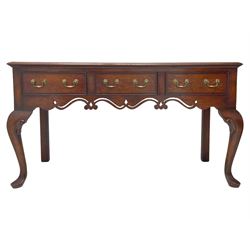 Georgian design oak and mahogany dresser base, the rectangular moulded top with mahogany band, three cocked-beaded and banded drawers over shaped a pierced apron, circular brass handle plates and swan neck handles, on C-scroll carved cabriole supports 