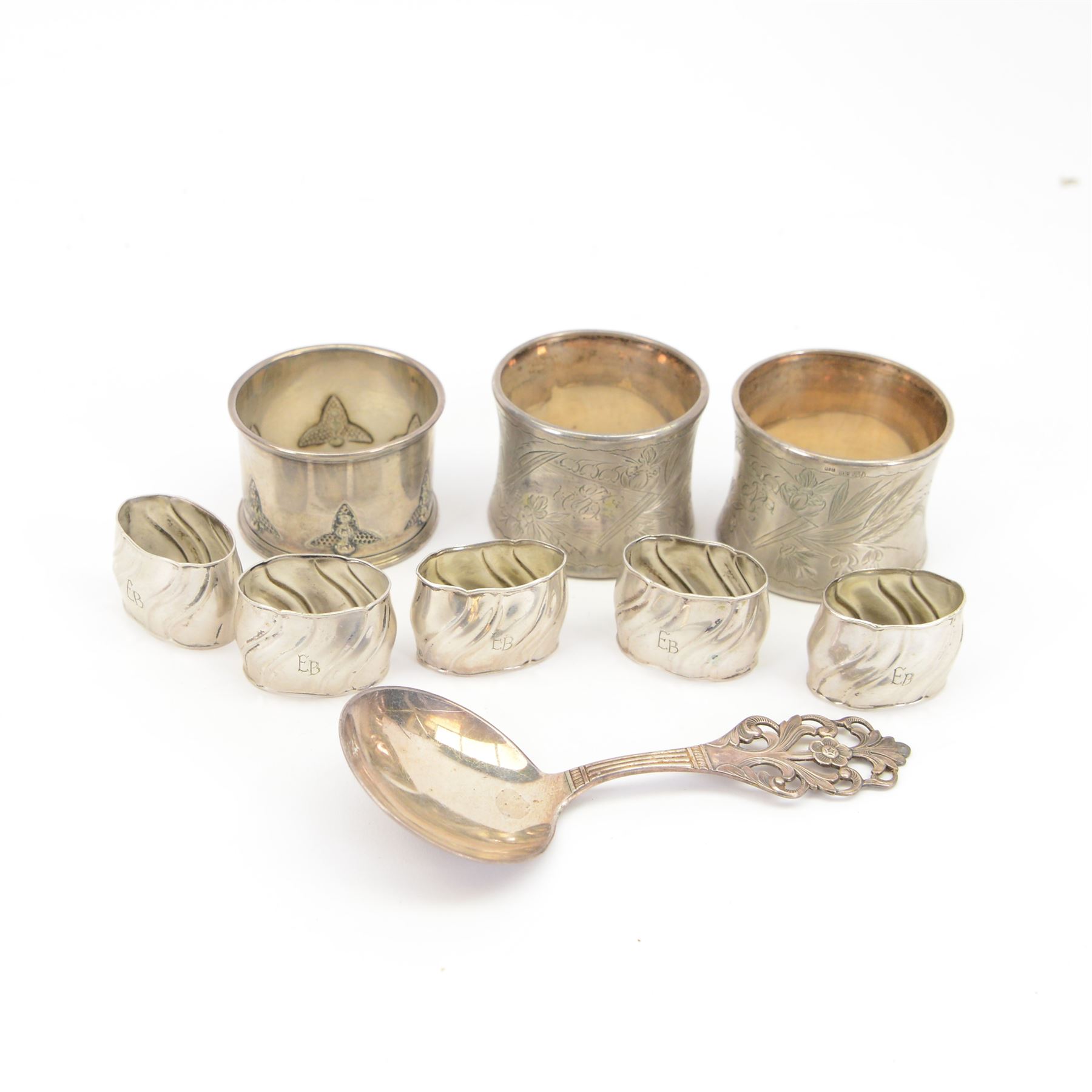 Norwegian silver spoon, with circular bowl and pierced floral handle, stamped 830S NM, for Magnus Aase, Norway, together with eight German silver napkin rings, including pair with engraved floral decoration, embossed example and five small fluted examples engraved with initials, all stamped 800 with crescent moon and crown marks