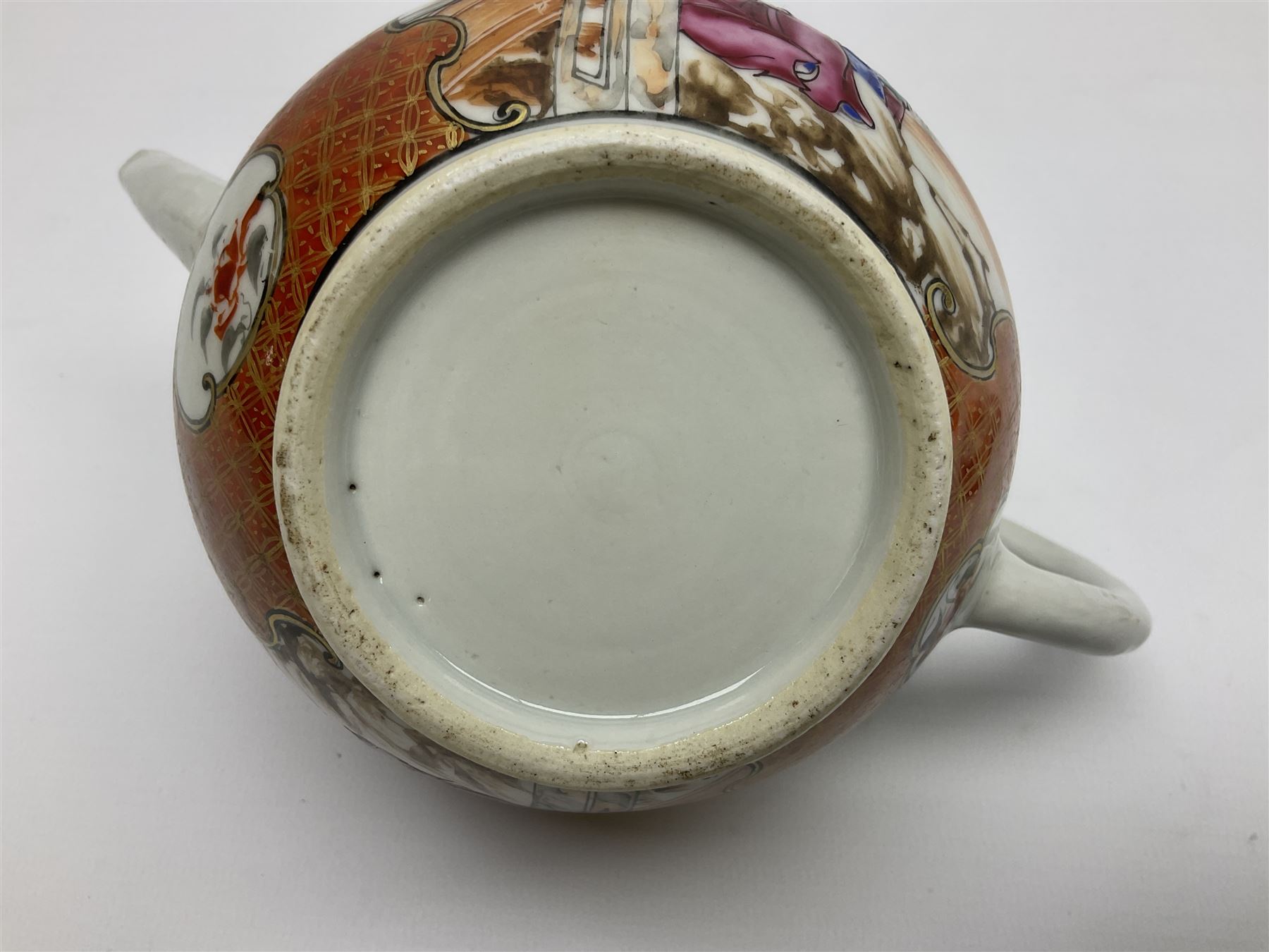 Two late 18th/early 19th century Chinese export teapots, the largest example of globular form with curved handle and straight spout, decorated in the Mandarin style with figural scenes surrounded by red scale reserves, H13.5cm, the second smaller example decorated in underglaze blue with two musicians in a landscape set with willow tree and fence, H10.5cm

