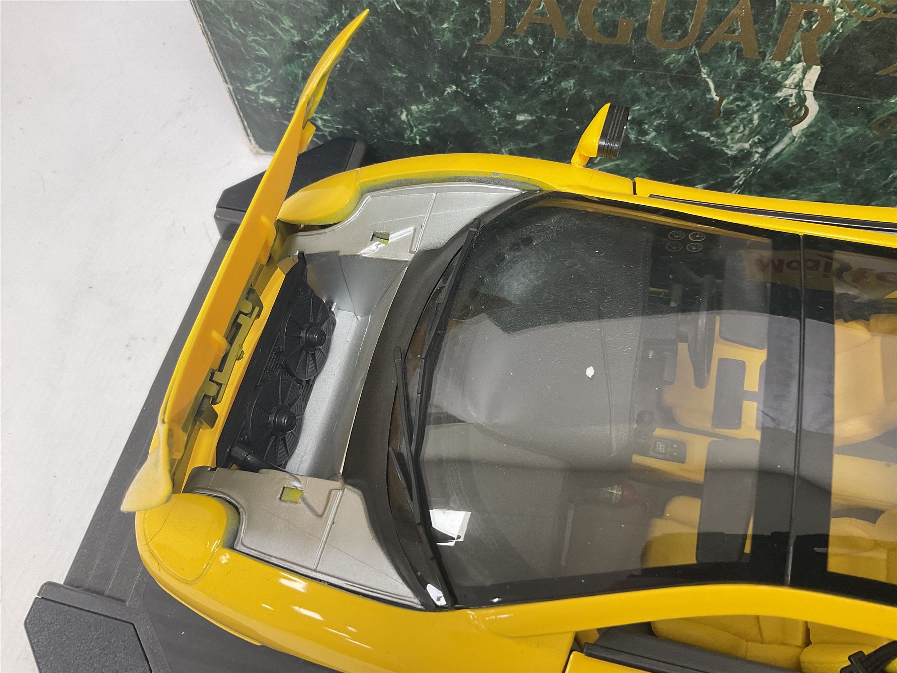 Two Maisto 1:12 scale Jaguar XJ220 ‘Racing’ cars in yellow, both on plinths in original boxes 