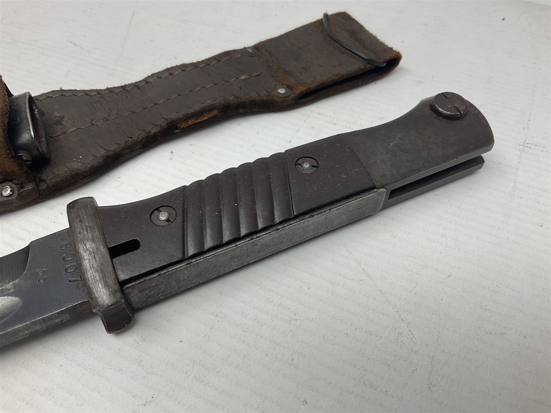 WWII German K98 Mauser bayonet by E. & F. Horster, the 24.5cm fullered blade marked 43aSW for 1943, numerous inspection marks to blade and pommel, bakelite grips and bluing to metal parts; in steel scabbard with corresponding numbers and leather frog L42cm overall