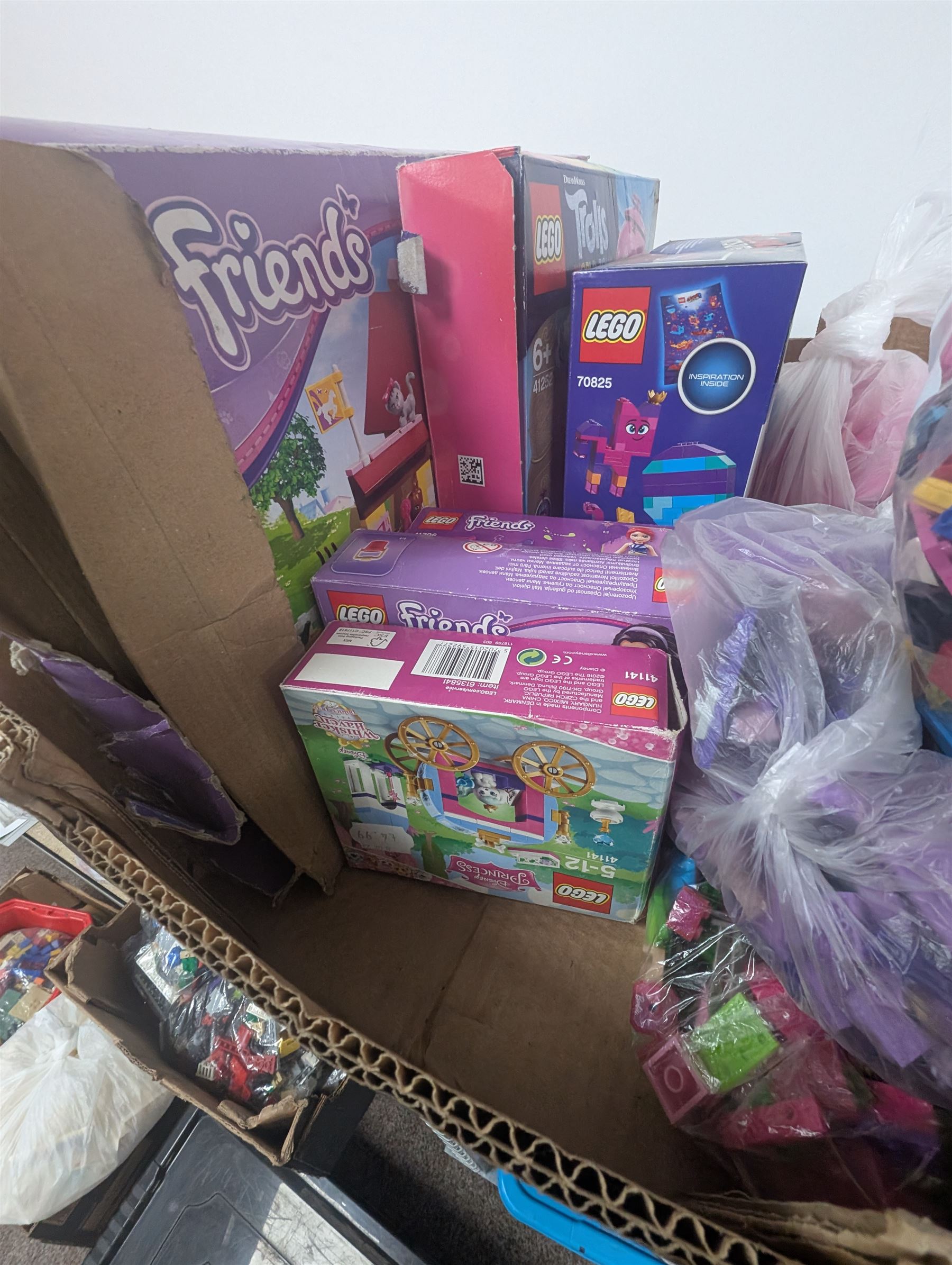 Lego Friends no. 3189 Stables set, Lego Trolls no. 41252 World Tour set, The Lego Movie set no. 70825, three small Lego Friends sets, all boxed and a quantity of loose Lego, including purple and pink colourways