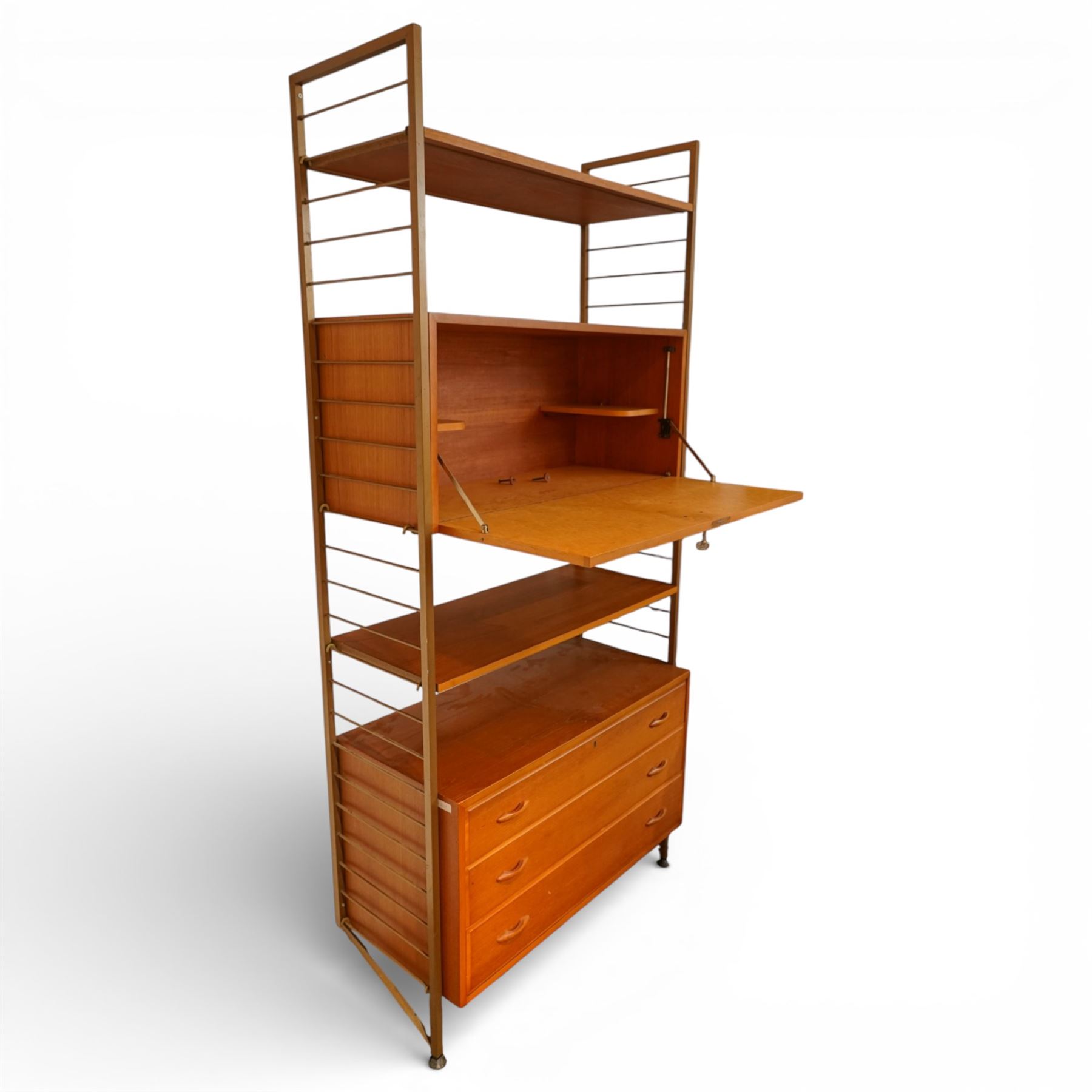 Staples - 'Ladderax' wall mounted modular teak unit, comprising two shelves, a fall front cabinet above three drawer unit below, supported on metal ladder frames 