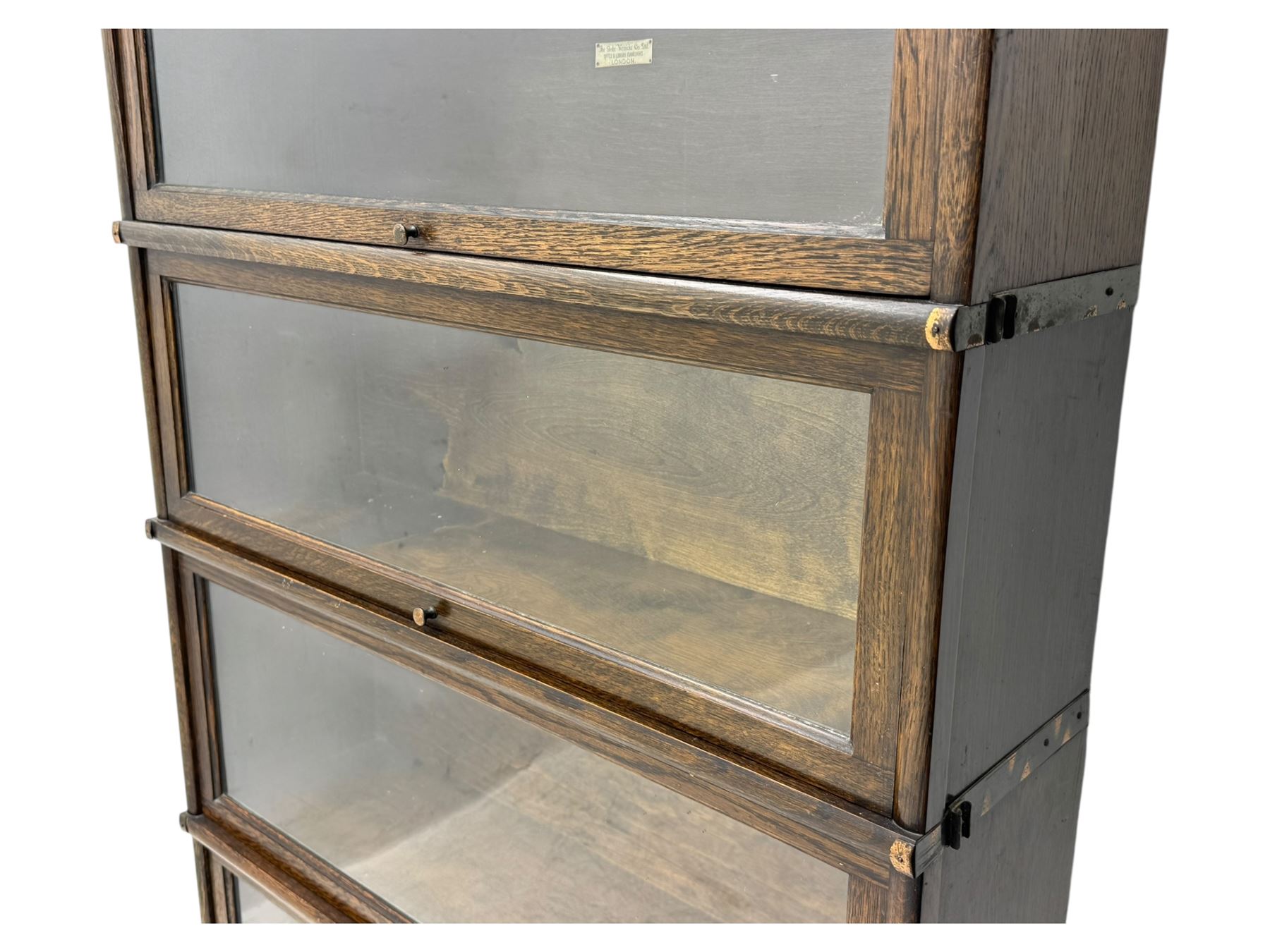 Globe Wernicke - stacking sectional library bookcase, over four glazed up-and-over doors, each bearing original makers mark, on moulded plinth base with inbuilt drawer