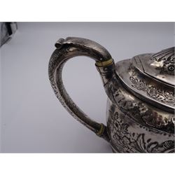 George III silver teapot, of oval form, with embossed foliate, floral and scroll decoration and engraved central cartouche, with acanthus capped C handle with ivory insulators, hallmarked John Emes, London 1807 This item has been registered for sale under Section 10 of the APHA Ivory Act
