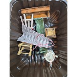 Two modern three storey dolls houses, each painted green with decorated interiors, both upon a single white wooden base, together with a large collection of dolls house furniture, accessories and figures 