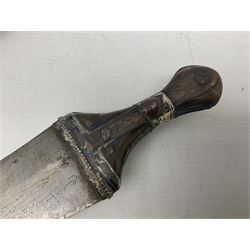 Late 19th/20th century Middle Eastern jambiya dagger the 36cm broad curved double edged steel blade with traces of script, horn and copper backed waisted white metal hilt with three roundel buttons; in ornate white metal and leather mounted brass and steel scabbard L60.5cm overall