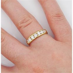 18ct gold channel set seven stone round brilliant cut diamond half eternity ring, stamped 750, total diamond 0.60