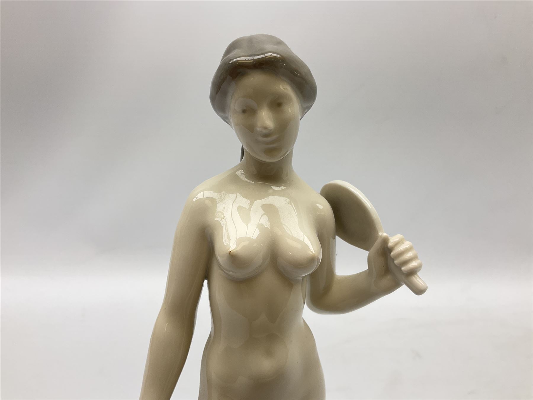 Royal Copenhagen 'Helena' figure modelled as a nude girl holding hand mirror, designed by Hans Hansen, model no. 4639, with printed and painted marks beneath, H25.5cm