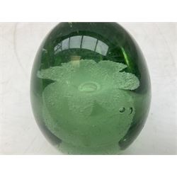 Pair of Victorian green glass dump paperweights with interior flower decoration, and another example with internal air bubble inclusions, tallest example H16cm