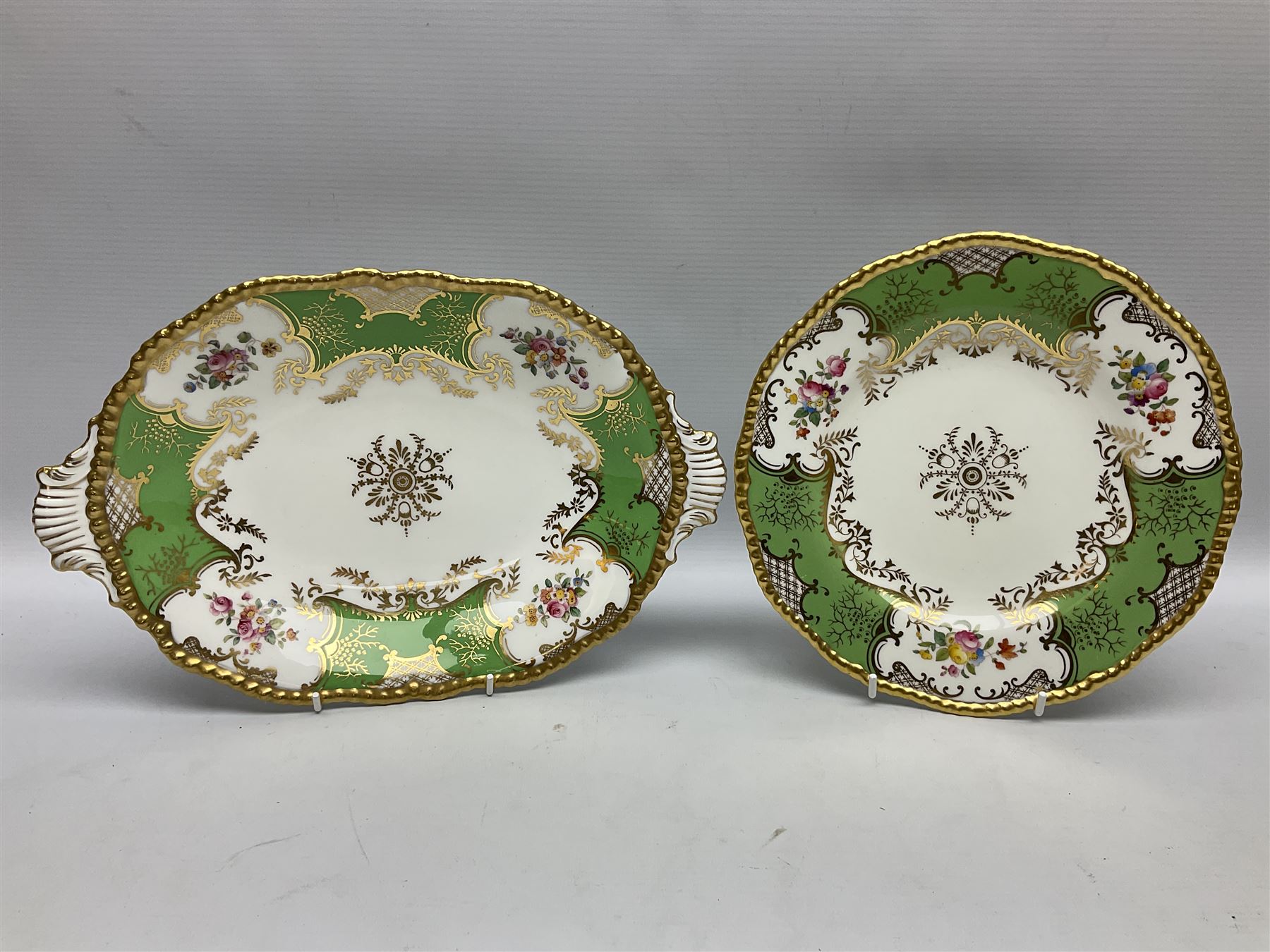 Coalport green batwing pattern tea wares, decorated with finely enamelled floral sprays within gilt reserves, comprising teacup trio, twin handled cake plate and side plate, pattern no Y2665, together with a Coalport for Harrods cup and saucer similarly decorated, the saucer with stamped mark beneath 'Manufactured for Harrods Ltd, Brompton Rd London', all with green Coalport AD 1750 marks beneath, largest W31cm (7)