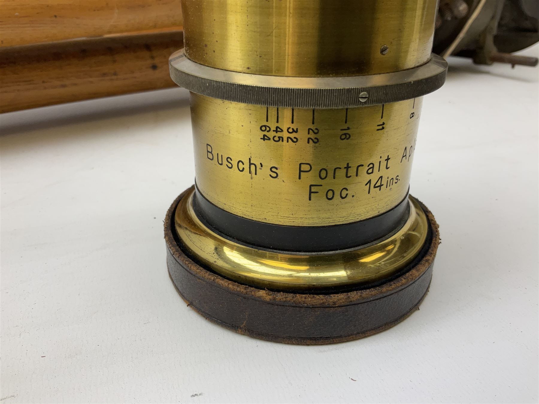 Thornton Pickard folding plate camera in mahogany and lacquered brass, no.529946 and no.529947, field model with canvas wrapped box, three mahogany photographic plates, 'Busch's Portrait Aplanat No4 Foc.14inc' lens and a wooden tripod