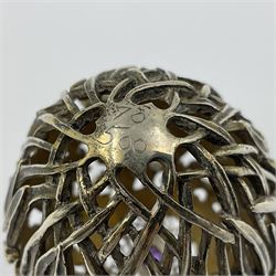 Modern silver limited edition Easter egg, no. 70/500, the gilt openwork body decorated with cascading bluebells and hinged cover with pierced circular panel set with a single faceted purple stone, opening to reveal a gilt interior, upon silver stand with three scrolling pad feet, each hallmarked St James House Company, London 1981, height including stand 8cm