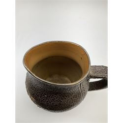 A Doulton Lambeth stoneware jug, with silver mounted collar, hallmarks rubbed, maker's mark probably Cornelius Desormeaux Saunders & James Francis Hollings (Frank) Shepherd, the leather effect body titled 'Drinke Faire Don't Sware', with impressed marks beneath including 'Manufactured for Sidney W Allen 39 White Rock Hastings', H18.5cm. 