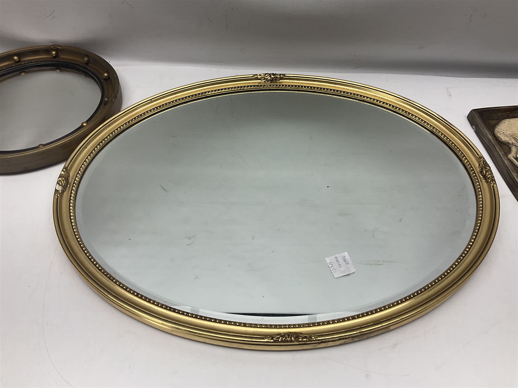 Two ceramic plaques by Richard Fisher, together with wooden plaques, artwork and three mirrors 