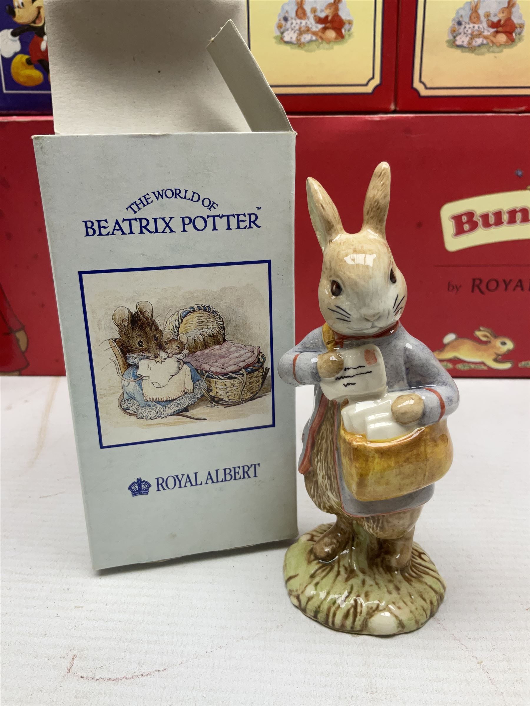 Royal Doulton The Mickey Mouse Collection Pluto figure, Coalport Characters The Snowman Dressing Up figure, three Royal Doulton Bunnykins figures comprising Policeman, Morris Danger and Eskimo, and display stand, Royal Doulton John Beswick Tiggy Winkle, Royal Albert Beatrix Potter Peter Postbag and three Goebel Hummel figures, all boxed