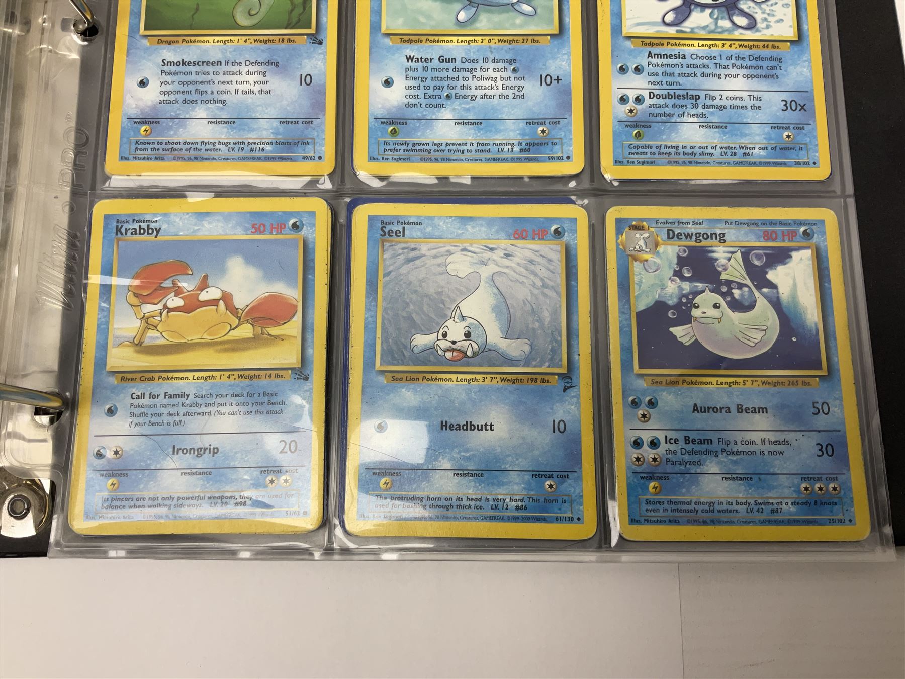 Collection of Pokemon trading cards, mostly 1999 Wizards Pokemon cards to include holo Charizard 4/102, first edition holo Machamp 8/102, further holographic cards; Dark Flareon 35/82 and Dark Vaporeon 45/82, cards from themed sets and 4th edition prints; 1998 Electronic Pokédex with cardboard boxes for themed decks Blackout, Overgrowth and Power Reserve Jungle, along with a large quantity of energy and trainer cards 