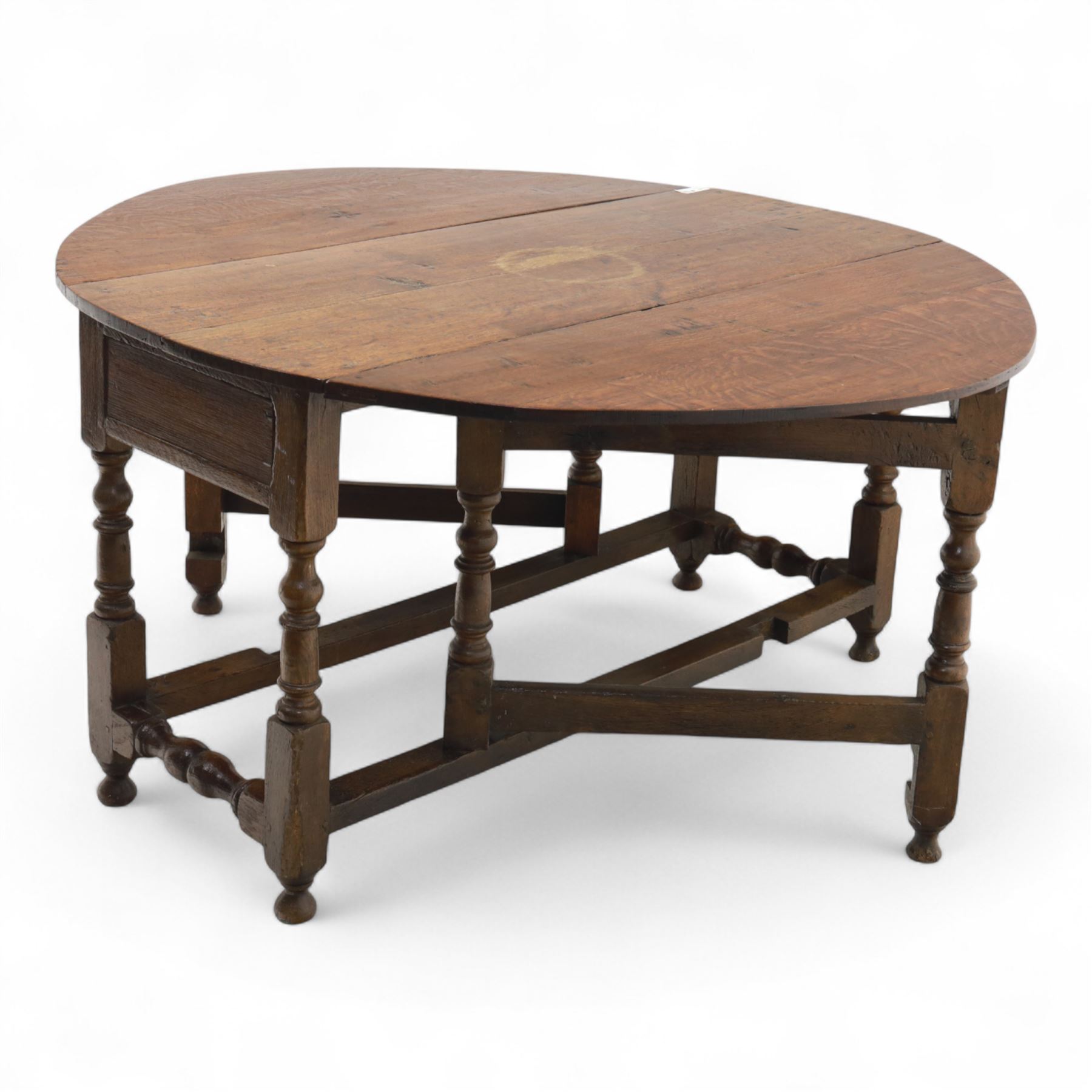 Early 19th century oak drop-leaf gateleg table, oval top above plain frieze, on ring turned legs joined by stretchers