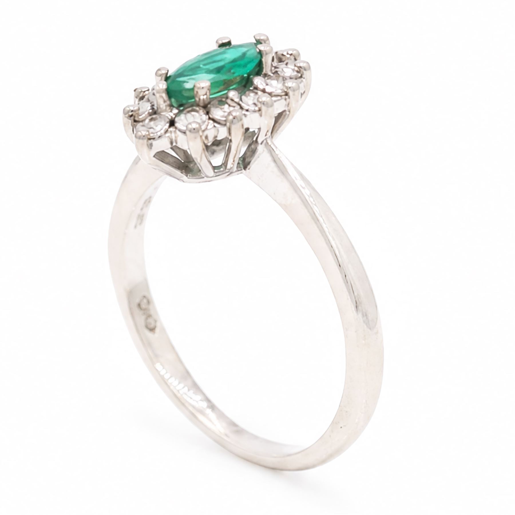 18ct white gold emerald and diamond cluster ring, single marquise cut emerald 0.25 carat, surrounded by twelve round brilliant cut diamonds, London 1979, total diamond weight approx 0.25 carat