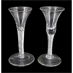 Two 18th century drinking glasses, the drawn trumpet and bell shaped bowls upon single series air twist stems and conical feet, each approximately H17cm