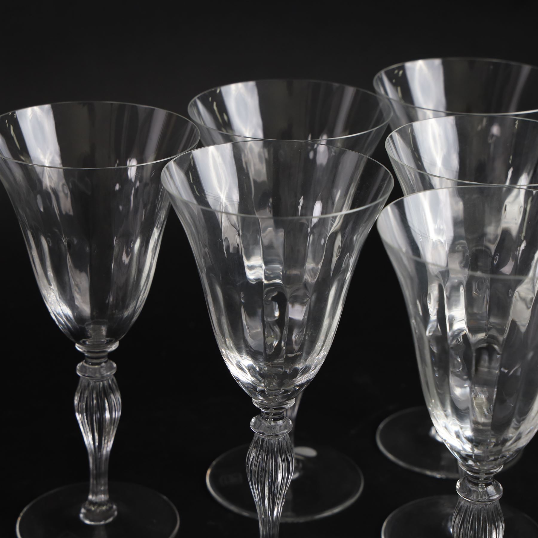 Set of six Murano clear glass wine glasses, each with part moulded fluted flared bowl, upon a knopped and fluted baluster stem and spreading circular foot, with etched marks beneath, H19.5cm