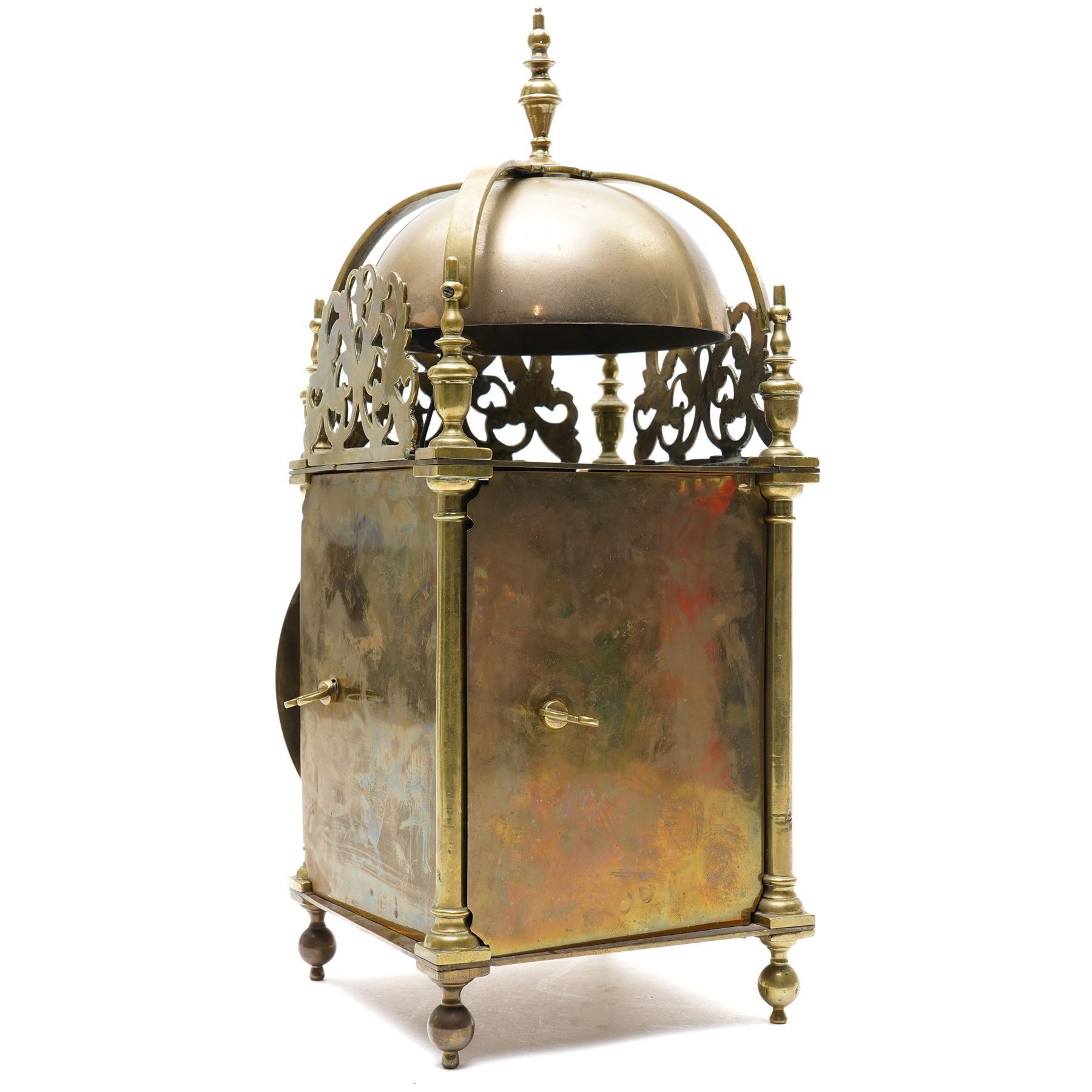 English-17th-century style replica 8-day lantern clock with a suspended bell and turned finials, with three ornate frets to the front and sides and opening side and rear doors, with an engraved dial centre and formerly silvered chapter with engraved Roman numerals, inner quarter hour track and period steel hands, dial engraved 