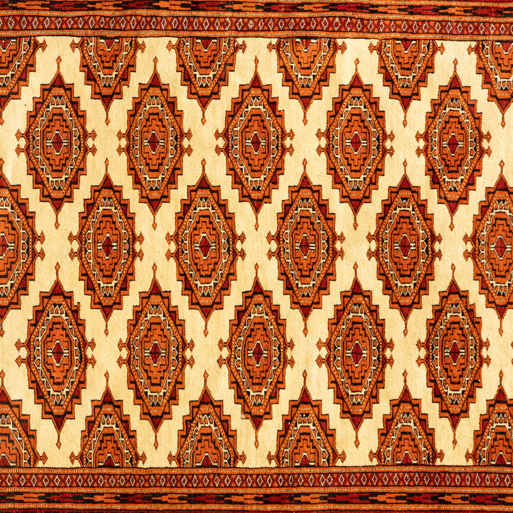 Three rugs,  comprising a Baluch rug in crimson ground, 179x97cm, a Tekke Bokhara rug in crimson ground, 201x132cm, and a Bokhara rug in ochre ground, 125x175cm 