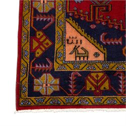 Turkish Anatolian hand-knotted carpet, red field centred by a large pale blue geometric medallion flanked by pink octagonal medallions, scattered stylised motifs, enclosed by multiple geometric borders