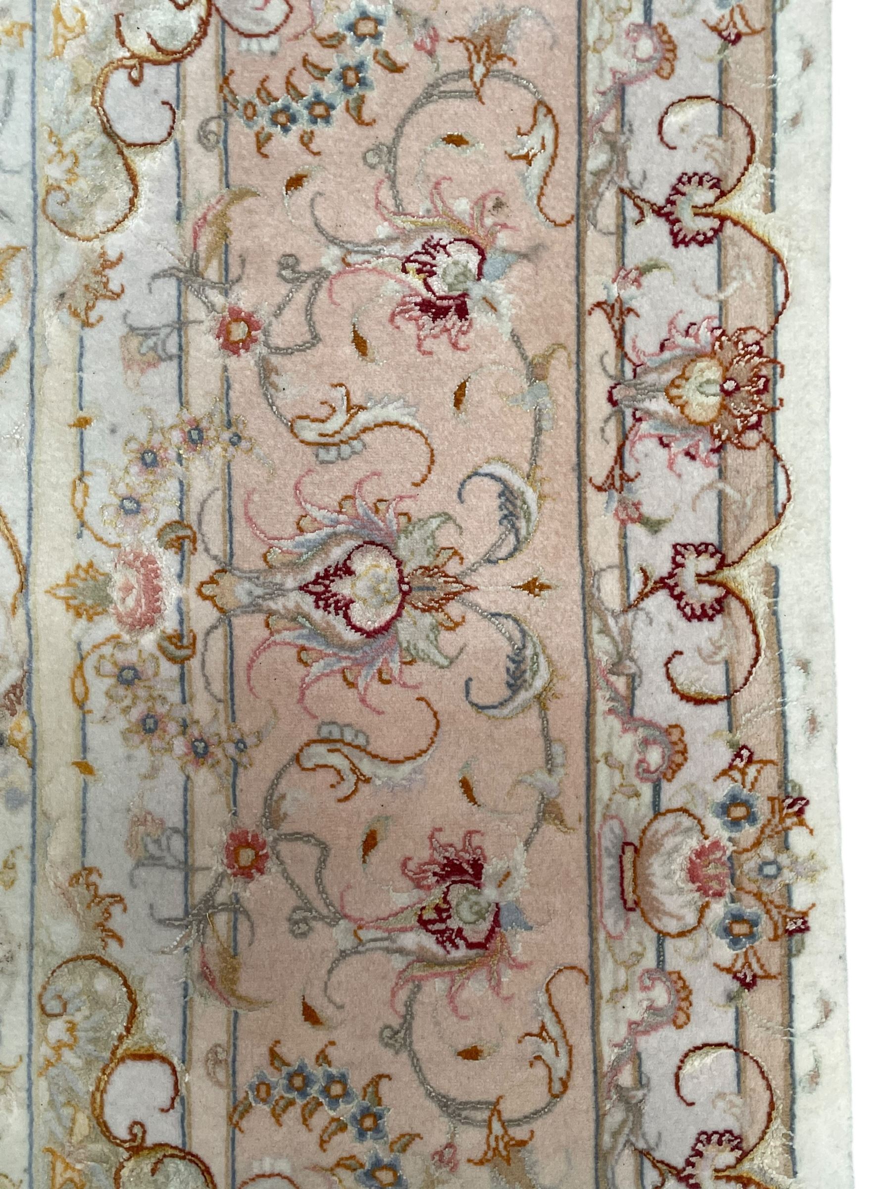 Persian Mahal densely knotted ivory ground carpet, floral rosette medallion surrounded by interlacing leafy branches and palmettes, scrolling border decorated with foliate motifs, within guard stripes, with signature panels to each end