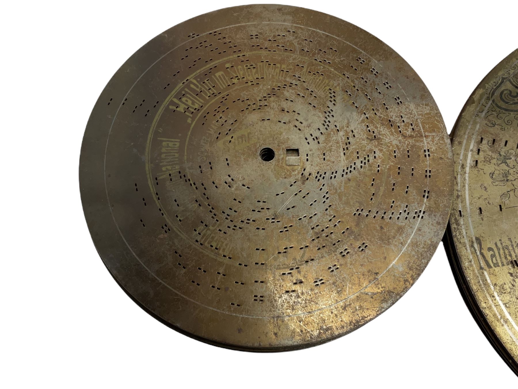 Late 19th century Symphonion disc musical box in inlaid walnut case with front lever action playing 25.5cm discs on a 10.5cm steel comb with forty-nine teeth, musical scene of cherubs under the lid, L33cm; together with five 25.5cm discs, fifteen 20.5cm discs and eleven 19cm discs