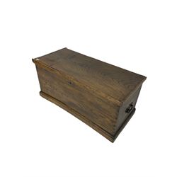 Elm blanket box, hinged lid enclosing candle box, fitted with metal carrying handles, on moulded plinth base