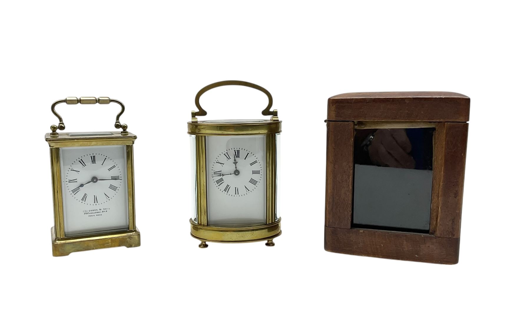 Two French early 20th century timepiece carriage clocks and a traveling case, both clocks with enamel dials, Roman numerals and steel hands, both with cylinder platform escapements.