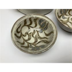 John Egerton (c1945-): studio pottery stoneware, comprising twin shallow covered dish, serving bowl and eight dessert bowls, all decorated with flowering sprigs on a cream ground, dish D28cm