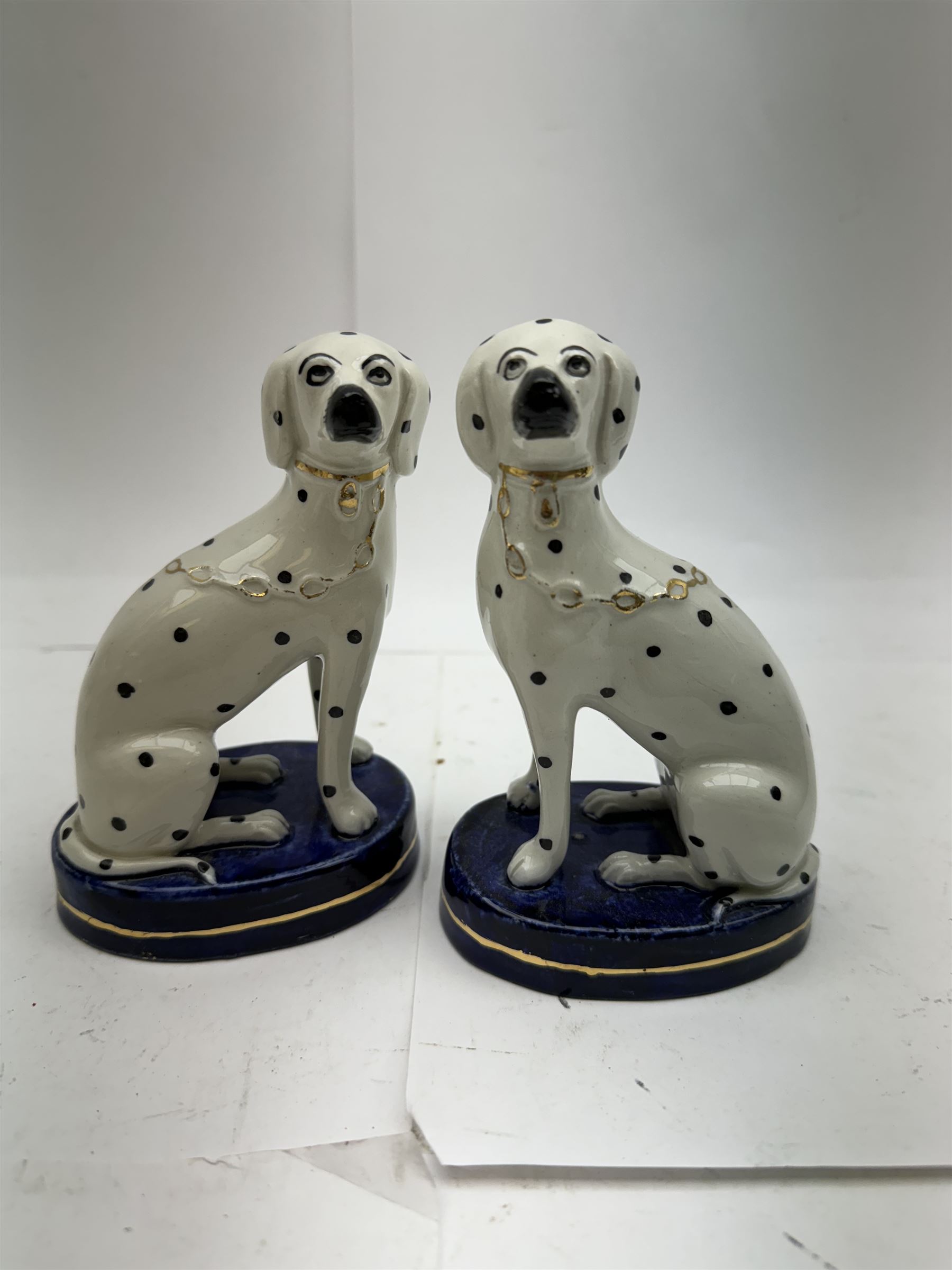 Pair of Staffordshire figures modelled as chained Dalmatians seated upon cobalt blue oval bases, H13cm, together with a Staffordshire pastille burner modelled as a castle, H12cm, a pair of 19th century Derby potpourri pots (lacking covers), and an 18th century blue and white tea bowl 