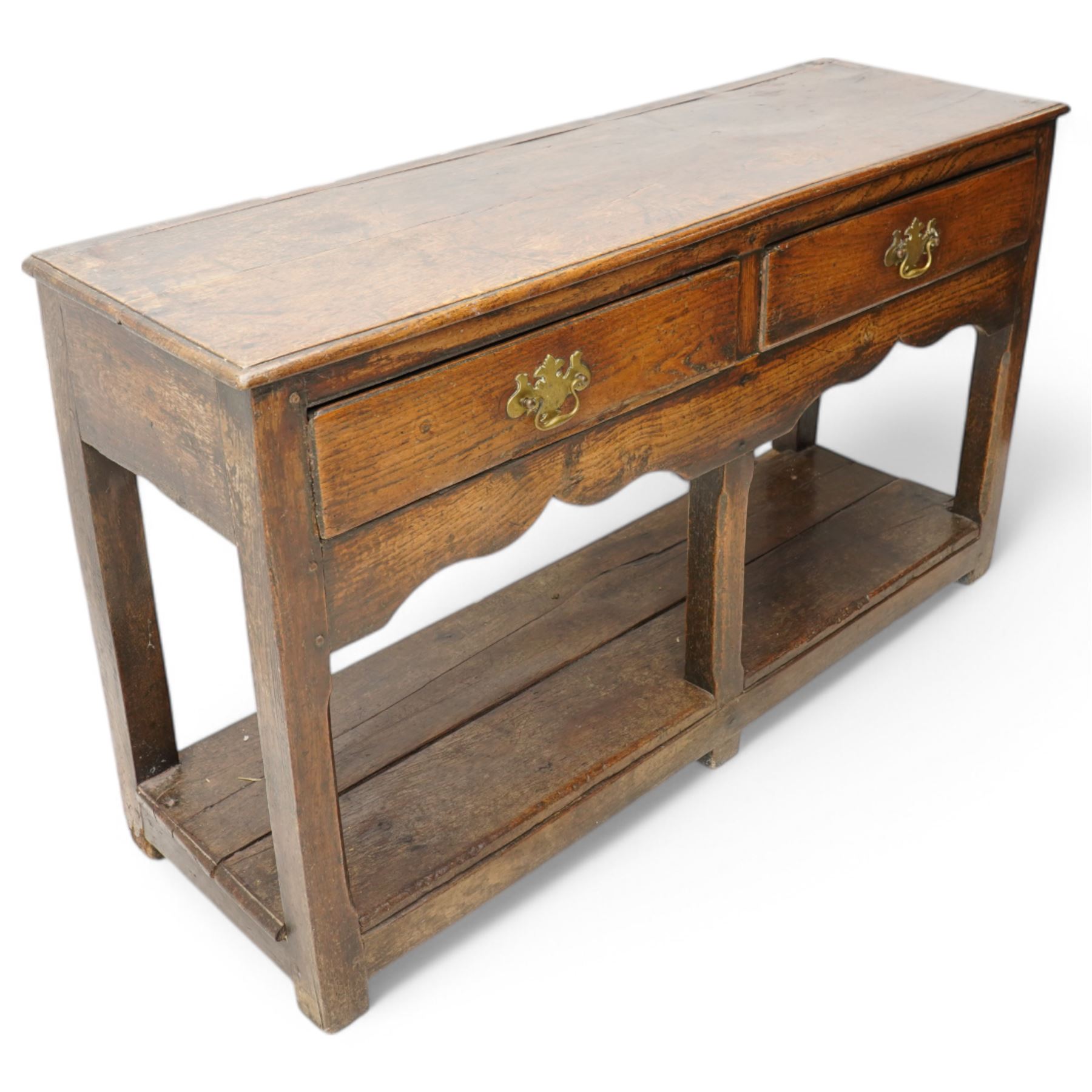 18th century oak dresser base, moulded rectangular top over two drawers and shaped apron, moulded drawer fronts fitted with shaped brass handle plates and swan neck handles, on chamfered square supports united by pot board base 