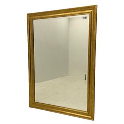 Bevelled mirror in moulded gilt frame