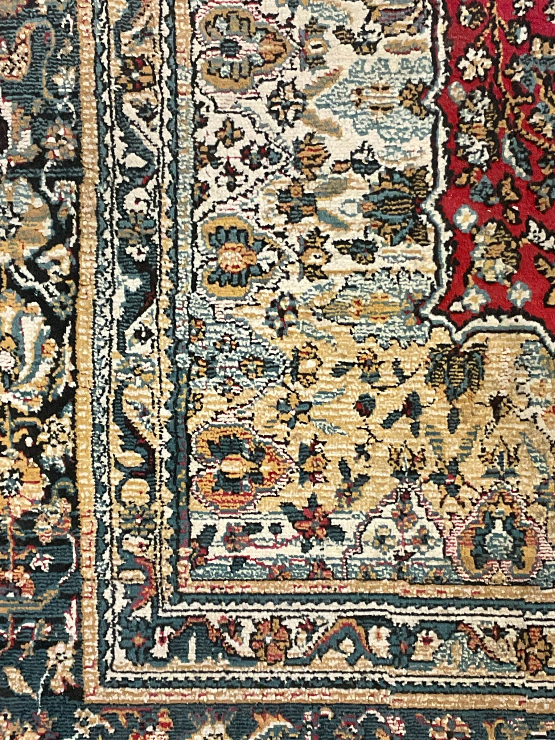 Persian design rug, rectangular crimson ground field with medallion, surrounded by trailing foliate branches, within wide border bands decorated with stylised floral motifs 