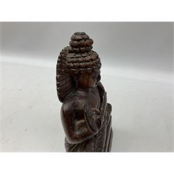 Hand carved wood figure of seated Buddha, modelled in the Vitarka Mudra pose, the head framed by a circular halo and clad in robes upon base, H25.5cm