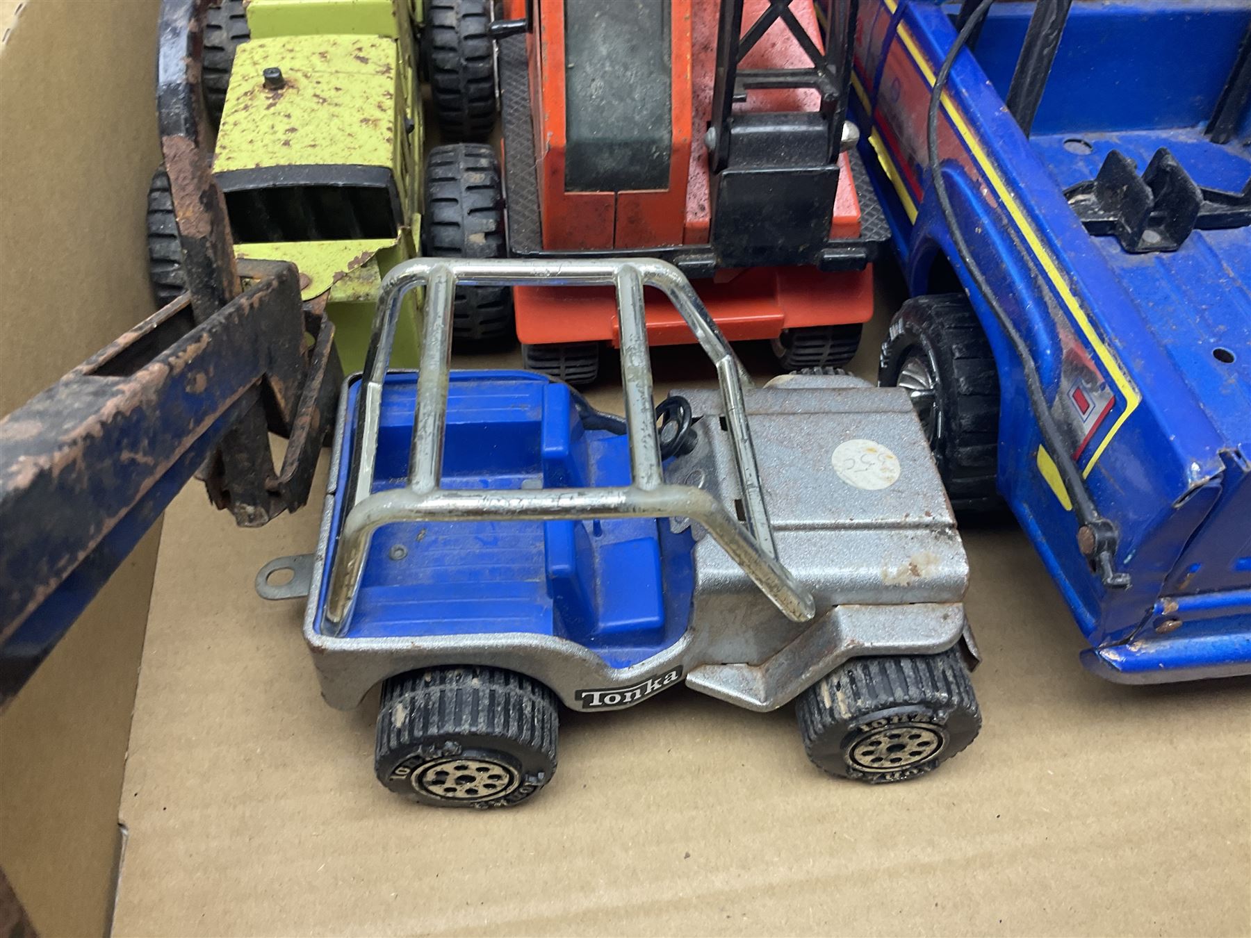Tonka - fourteen pressed steel vehicles including Pick-up Truck, Tractor Digger, Mobile Crane, Trencher, Beach Buggy, two Bulldozers, Digger, Low Loader, Farm Trucks etc; and small quantity of spare parts (14)