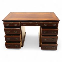 Early 20th century Indian hardwood pedestal desk, rectangular top with moulded edge over three frieze drawers, twin pedestals each fitted with four drawers, brass pierced swing handles and brass escutcheons, upon plinth bases  