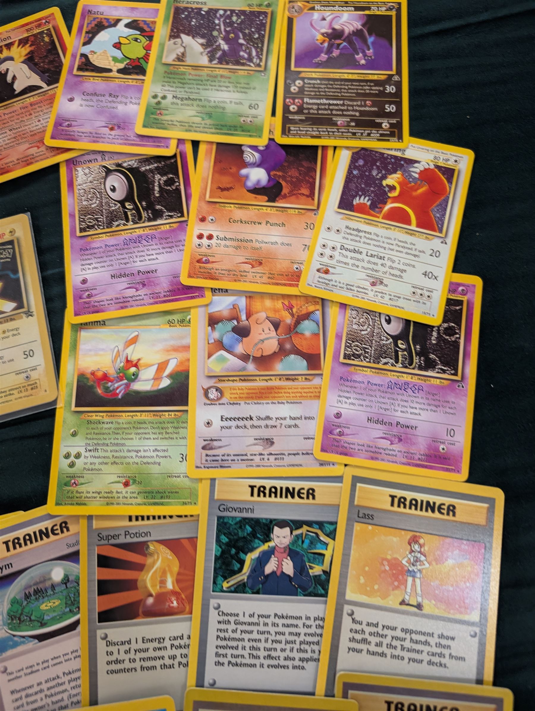 Collection of Pokemon TGC trading cards, including two WB First Movie Black Star promo cards Pikachu no. 4 and Dragonite no. 5, two Ancient Mew Black Star holo promo cards, Gym Challenge Giovanni's Persian 8/132 holo and a small collection WOTC, Neo Discovery and Neo Genesis cards, together with thirty four Bandai Carddass Pokemon cards, including prism Charizard no. 186 and Pokemon Topps cards including holo examples 