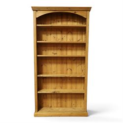 Traditional large pine bookcase, moulded cornice above five adjustable shelves